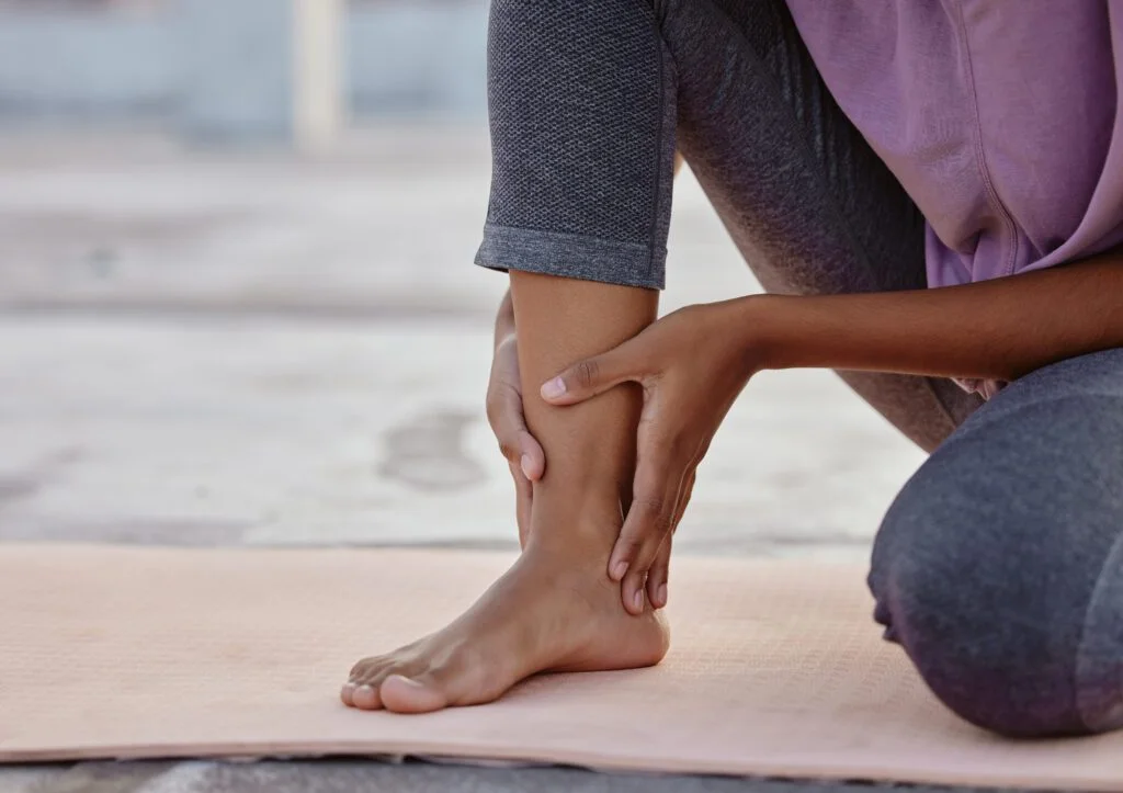 Person holding their ankle