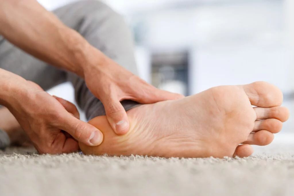 Person massaging their own heel